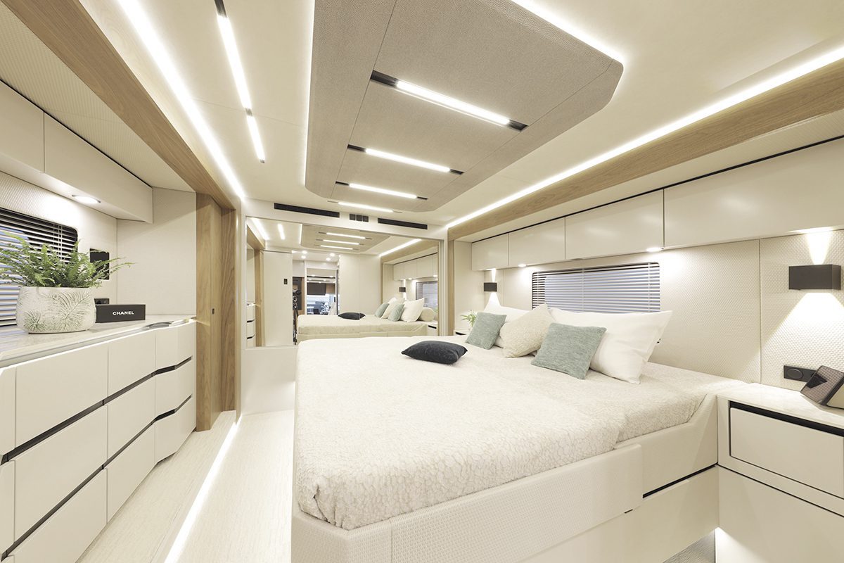 Sleek master bedroom interior inside the Vario mobile vehicle with a double bed, wooden accents, and integrated LED strip lighting