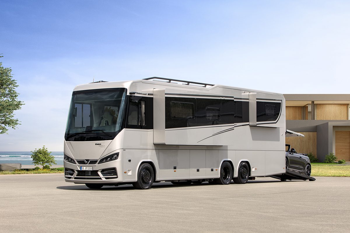 Exterior side view of the Vario Perfect luxury motorhome parked outdoors with a car stored in the rear garage